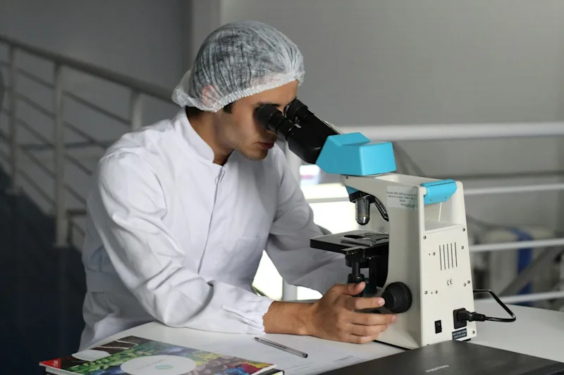 Student inspects sample for signs of fertility in Douchewater Enterprises Lab AA